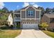 Charming two-story home featuring stone accents, a two-car garage, and a cozy porch at 218 Maple Walk St, Durham, NC 27703