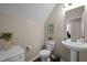 Cozy half bathroom showcasing pedestal sink, toilet, and decorative accents at 218 Maple Walk St, Durham, NC 27703