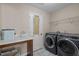 Well-equipped laundry room featuring modern washer and dryer, ample counter space, and convenient storage solutions at 218 Maple Walk St, Durham, NC 27703