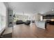 Spacious living room with hardwood floors and comfortable black leather seating at 218 Maple Walk St, Durham, NC 27703