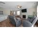 Bright living room featuring a fireplace, ceiling fan, and comfortable gray seating at 218 Maple Walk St, Durham, NC 27703
