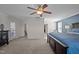 Well-lit main bedroom offering plush carpeting, a ceiling fan, and plenty of room at 218 Maple Walk St, Durham, NC 27703