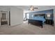Bright main bedroom with plush carpet, blue accent wall, ceiling fan, and lots of space at 218 Maple Walk St, Durham, NC 27703