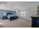 Spacious main bedroom featuring a blue accent wall, plush carpeting, and great natural light at 218 Maple Walk St, Durham, NC 27703