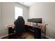 Home office setup with ergonomic chair, dual monitors, and ample desk space at 218 Maple Walk St, Durham, NC 27703