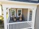 Cozy porch featuring neutral tones, comfy seating, and ample natural light through white framed windows at 218 Maple Walk St, Durham, NC 27703