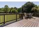 Back deck with a dining table and chair set overlooking a sprawling lawn at 2213 Ravens Creek Ct, Raleigh, NC 27603