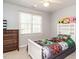 Neutrally decorated bedroom with dresser, bookshelf, and whimsical Minecraft themed bedding at 2213 Ravens Creek Ct, Raleigh, NC 27603