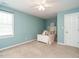 Sunlit bedroom featuring a bright color scheme, plush carpeting, and a cozy unicorn plushie at 2213 Ravens Creek Ct, Raleigh, NC 27603