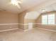 Spacious bonus room with plush carpeting, neutral color scheme, and dormer windows at 2213 Ravens Creek Ct, Raleigh, NC 27603