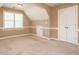Bonus room featuring carpeted floors, multiple storage areas, and dormer style ceilings at 2213 Ravens Creek Ct, Raleigh, NC 27603