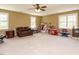 Spacious bonus room with carpet, ceiling fan, and natural light from large windows at 2213 Ravens Creek Ct, Raleigh, NC 27603
