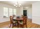 Charming dining area featuring wood floors, natural light, and a dark front door nearby at 2213 Ravens Creek Ct, Raleigh, NC 27603