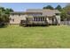 View of backyard and rear exterior featuring a deck and sprawling lawn at 2213 Ravens Creek Ct, Raleigh, NC 27603