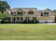 Traditional two-story home with a well-manicured front lawn at 2213 Ravens Creek Ct, Raleigh, NC 27603