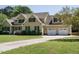 Beautiful home showcasing manicured lawn, garage and an inviting driveway at 2213 Ravens Creek Ct, Raleigh, NC 27603