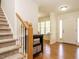 Welcoming foyer with hardwood floors and staircase leading to the second level at 2213 Ravens Creek Ct, Raleigh, NC 27603