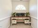 Cozy home office space featuring built in desk, an arched window, and neutral decor at 2213 Ravens Creek Ct, Raleigh, NC 27603