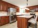 Well-equipped kitchen featuring stainless steel appliances, an island, and sleek countertops at 2213 Ravens Creek Ct, Raleigh, NC 27603