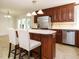 The kitchen with an island and seating, stainless steel appliances, and warm wood cabinets at 2213 Ravens Creek Ct, Raleigh, NC 27603