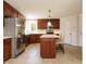 Spacious kitchen featuring custom wood cabinets, stainless steel appliances, and a kitchen island at 2213 Ravens Creek Ct, Raleigh, NC 27603