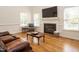 Comfortable living room with a fireplace, hardwood floors, and ample natural light at 2213 Ravens Creek Ct, Raleigh, NC 27603