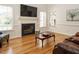 Inviting living room with a cozy fireplace, hardwood floors, and bright windows at 2213 Ravens Creek Ct, Raleigh, NC 27603