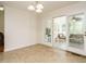 Sunlit room with tile floors and sliding doors leading to an enclosed porch at 2213 Ravens Creek Ct, Raleigh, NC 27603