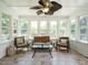 Bright sunroom with tile floors, ample windows, and comfortable seating at 2213 Ravens Creek Ct, Raleigh, NC 27603