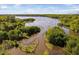 Aerial view of the lush, green, wooded community and waterfront with a large lake and river ways at 2221 Dungiven Ct, Garner, NC 27529