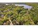 An aerial view of a lush, green, wooded community near a large lake on a sunny day at 2221 Dungiven Ct, Garner, NC 27529
