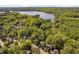 Aerial view showing a neighborhood with mature trees and lake access at 2221 Dungiven Ct, Garner, NC 27529