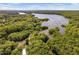 An aerial view of the landscape, showcasing the lush, green, wooded community, rivers, and the lake at 2221 Dungiven Ct, Garner, NC 27529