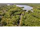 An aerial view of a lush, green, wooded community with a river flowing towards a large lake at 2221 Dungiven Ct, Garner, NC 27529