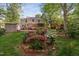 Expansive backyard with lush landscaping, a deck, and a storage shed at 2221 Dungiven Ct, Garner, NC 27529