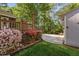 Landscaped backyard with colorful azaleas, a deck, and mature trees at 2221 Dungiven Ct, Garner, NC 27529