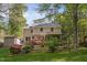 Spacious backyard featuring mature trees, lush landscaping, and a storage shed at 2221 Dungiven Ct, Garner, NC 27529