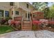 Beautiful backyard with lush landscaping, colorful azaleas, and a wooden deck with steps at 2221 Dungiven Ct, Garner, NC 27529