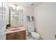 Powder room featuring a vanity, toilet and floral wallpaper at 2221 Dungiven Ct, Garner, NC 27529