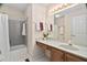 Charming bathroom with patterned wallpaper, shower-tub, and classic sink and vanity at 2221 Dungiven Ct, Garner, NC 27529