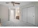 Neutral bedroom with ceiling fan, plush carpet, bi-fold closet and doorway to hall at 2221 Dungiven Ct, Garner, NC 27529