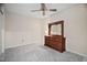 Bright bedroom featuring neutral paint, ceiling fan, plush carpet, and classic wood dresser with mirror at 2221 Dungiven Ct, Garner, NC 27529