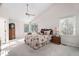 Bright bedroom with vaulted ceiling, ceiling fan, large windows, and plush carpet at 2221 Dungiven Ct, Garner, NC 27529