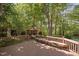 Deck with wooden railing and bench, overlooking the backyard and a charming gazebo at 2221 Dungiven Ct, Garner, NC 27529