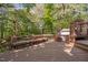 Deck with built in bench and pergola feature overlooking mature backyard at 2221 Dungiven Ct, Garner, NC 27529