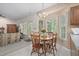 Bright dining area with a wooden table set and floral wallpaper accent at 2221 Dungiven Ct, Garner, NC 27529