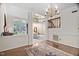 Elegant dining room with hardwood floors, large windows, and a chandelier at 2221 Dungiven Ct, Garner, NC 27529