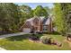 Two-story brick home with a well-maintained lawn, featuring a beautiful flowerbed and a two-car garage at 2221 Dungiven Ct, Garner, NC 27529