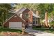 Lovely brick home with an attached garage, surrounded by green lawn and mature trees at 2221 Dungiven Ct, Garner, NC 27529
