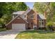 Beautiful brick home with manicured lawn, flowering bushes, and a two-car garage at 2221 Dungiven Ct, Garner, NC 27529